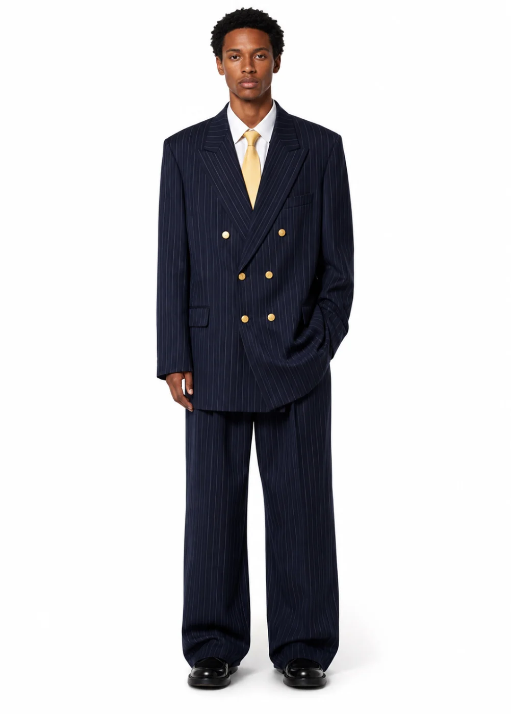 Full-length product photo of a man in a navy pinstripe double-breasted suit, white shirt and yellow tie on a plain white background.